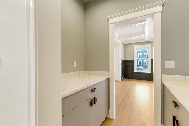 bathroom with baseboards and wood finished floors