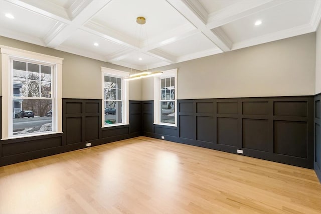 empty room featuring light wood-type flooring, coffered ceiling, beamed ceiling, and recessed lighting