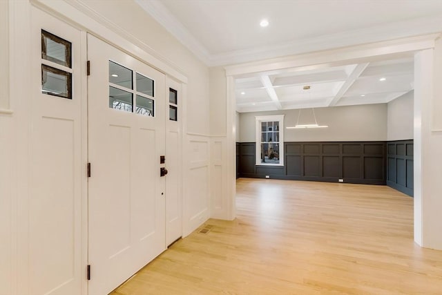 entryway with light wood finished floors, coffered ceiling, beamed ceiling, crown molding, and recessed lighting