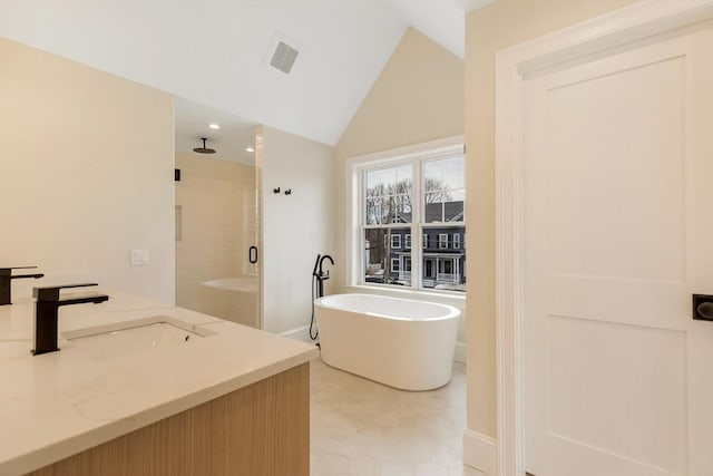 bathroom with a sink, visible vents, vaulted ceiling, a soaking tub, and a shower stall