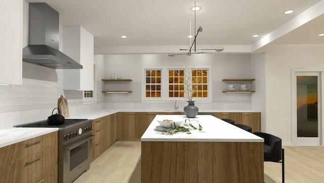 kitchen with decorative backsplash, wall chimney exhaust hood, a breakfast bar, high end stainless steel range, and a kitchen island