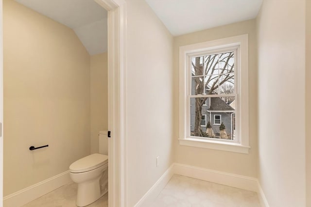 bathroom featuring toilet and baseboards