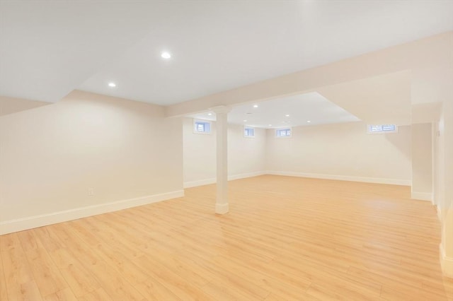 below grade area with light wood-type flooring, baseboards, and recessed lighting