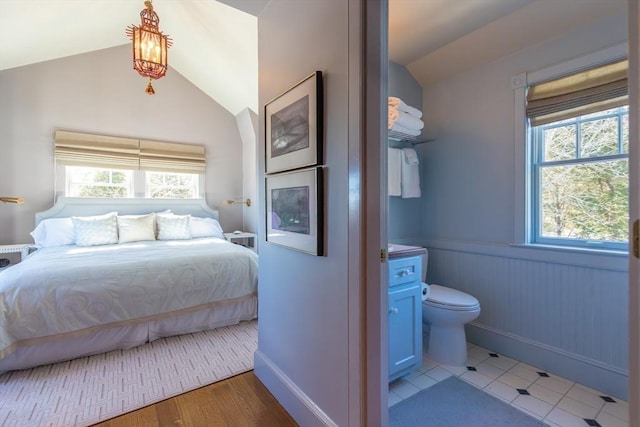 17 Mattarest Ln, Dartmouth, MA 02748 - bedroom with vaulted ceiling, multiple windows, and wainscoting