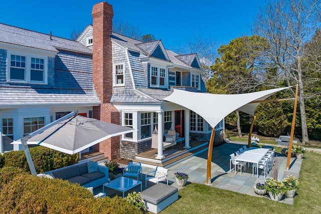 17 Mattarest Ln, Dartmouth, MA 02748 - rear view of property featuring outdoor lounge area, a chimney, a patio, and outdoor dining area