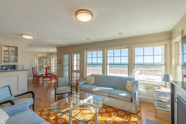 17 Mattarest Ln, Dartmouth, MA 02748 - living area featuring a chandelier, wood finished floors, view of water and beach, and crown molding