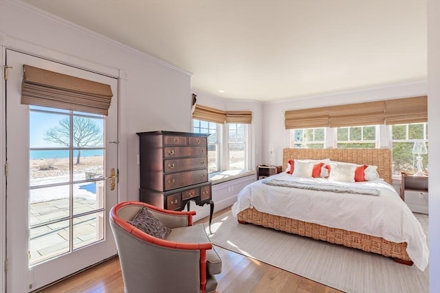 17 Mattarest Ln, Dartmouth, MA 02748 - bedroom featuring wood finished floors, access to exterior, ornamental molding, and a water view