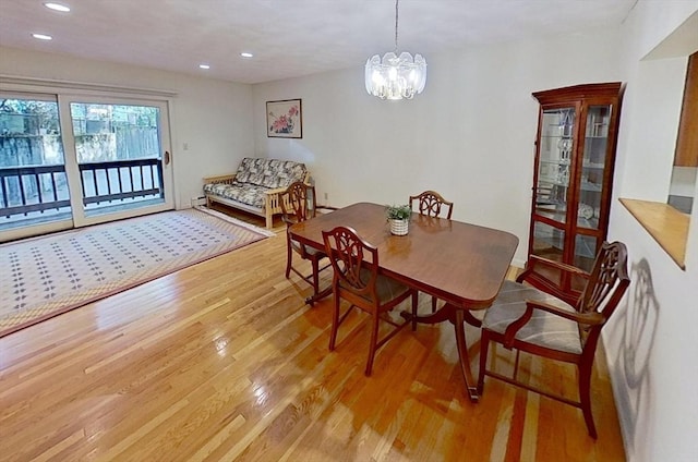 dining space featuring light wood-type flooring, recessed lighting, and a chandelier