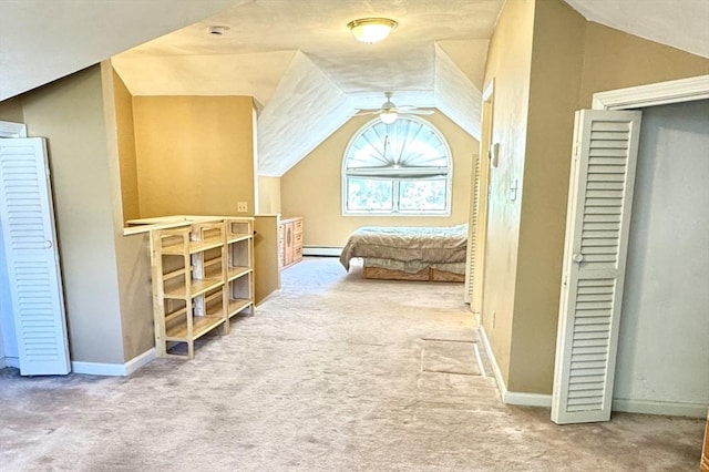 additional living space featuring carpet, a ceiling fan, vaulted ceiling, a baseboard radiator, and baseboards