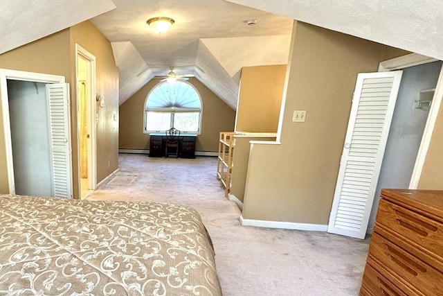 bedroom with carpet flooring, baseboard heating, vaulted ceiling, and baseboards