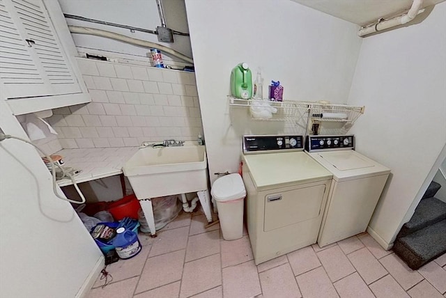 washroom with washer and dryer and light tile patterned flooring