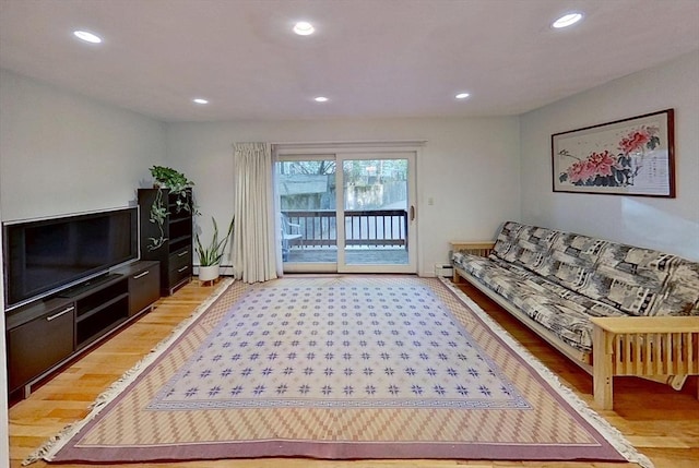 living area with light wood-style floors and recessed lighting