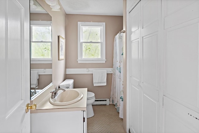 bathroom with vanity, toilet, a textured ceiling, and a baseboard radiator