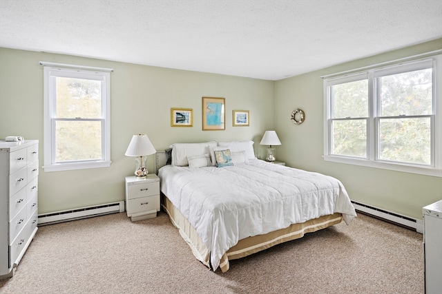 bedroom featuring light carpet, a textured ceiling, and a baseboard radiator