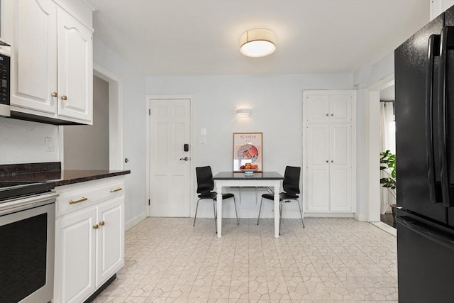 141 Jewett St Unit 2, Newton, MA 02458 - kitchen with freestanding refrigerator, electric range, and white cabinetry