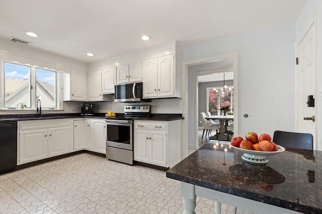 141 Jewett St Unit 2, Newton, MA 02458 - kitchen featuring black appliances, a sink, white cabinetry, dark stone counters, and recessed lighting