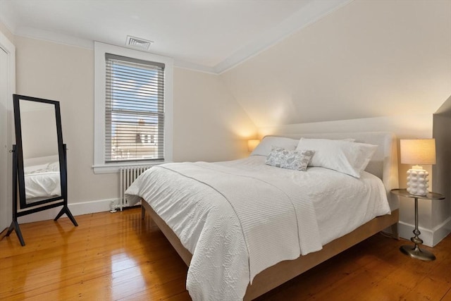 141 Jewett St Unit 2, Newton, MA 02458 - bedroom featuring radiator, ornamental molding, hardwood / wood-style floors, and baseboards