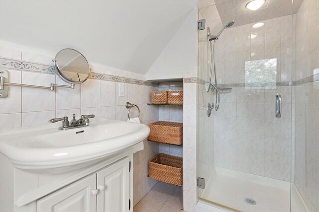 141 Jewett St Unit 2, Newton, MA 02458 - bathroom with tile walls, a shower stall, vanity, and tile patterned floors