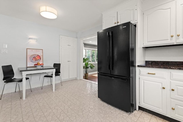 141 Jewett St Unit 2, Newton, MA 02458 - kitchen featuring freestanding refrigerator, white cabinetry, dark stone countertops, and baseboards