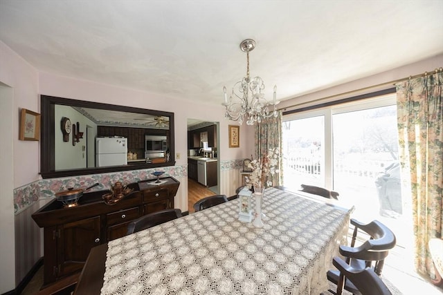 dining area featuring an inviting chandelier