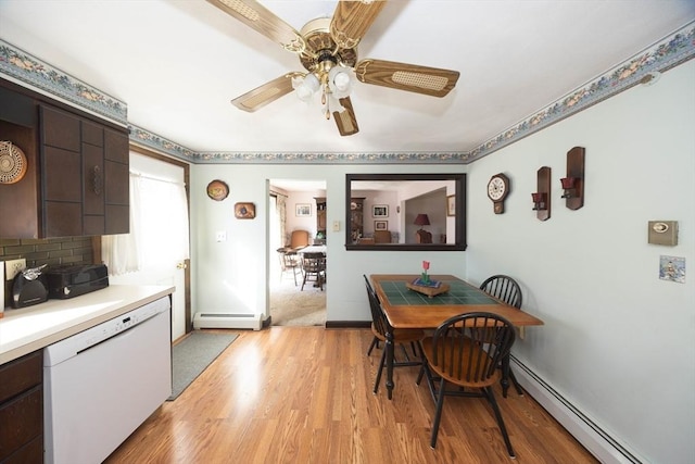 dining area featuring light wood-type flooring, a baseboard radiator, baseboards, and ceiling fan