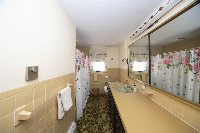 full bath featuring a wainscoted wall, tile walls, curtained shower, toilet, and vanity