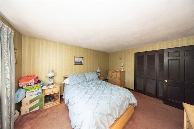 bedroom with a closet, carpet, and wallpapered walls