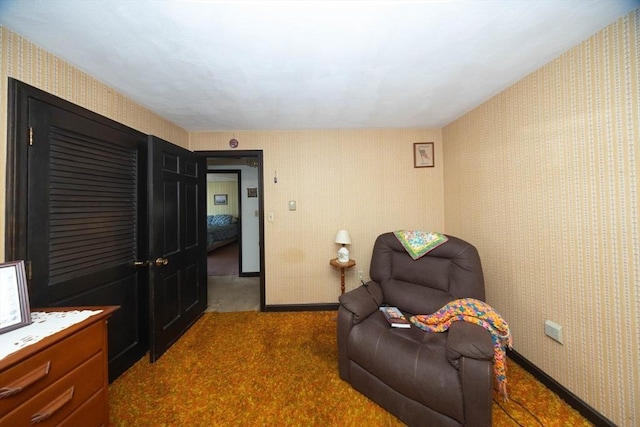 sitting room featuring carpet, baseboards, and wallpapered walls