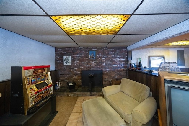 bar featuring tile patterned flooring and a drop ceiling