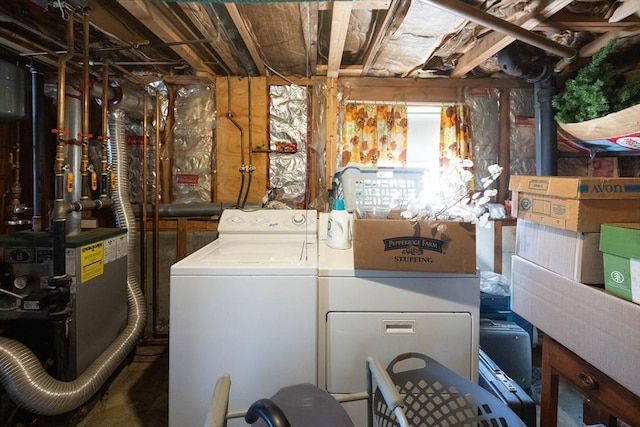 clothes washing area with laundry area, a heating unit, and washing machine and clothes dryer