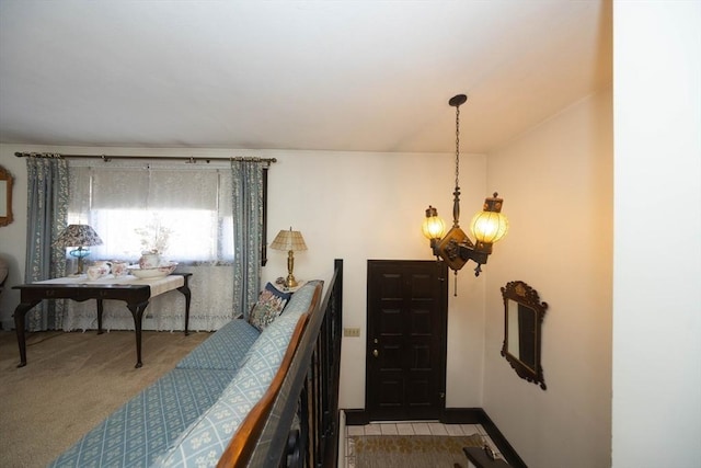 interior space featuring baseboards and a chandelier