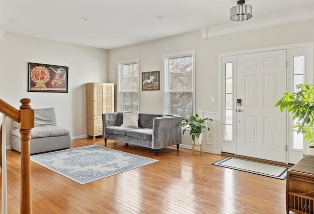 foyer entrance with stairway, light wood-type flooring, and baseboards