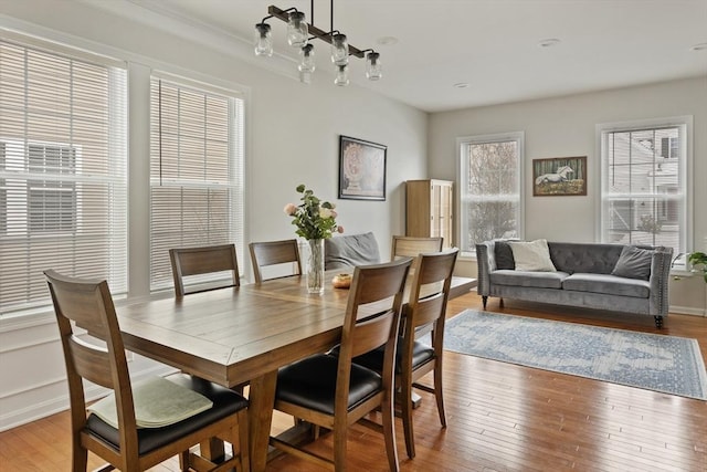 dining room with a chandelier and light wood-style flooring