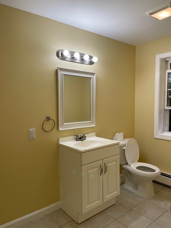 bathroom featuring vanity, toilet, and tile patterned floors