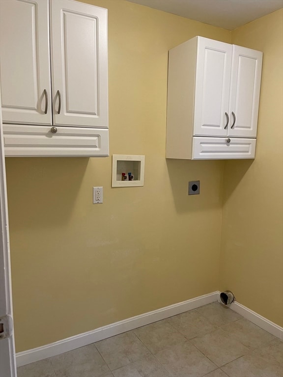 laundry area featuring washer hookup, cabinets, light tile patterned floors, and electric dryer hookup