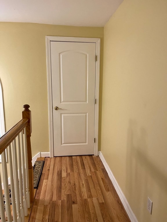 hall with wood-type flooring