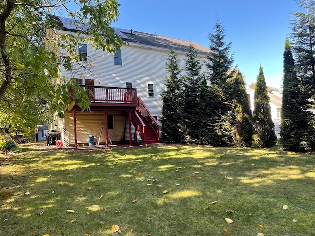 back of property with a lawn and a wooden deck