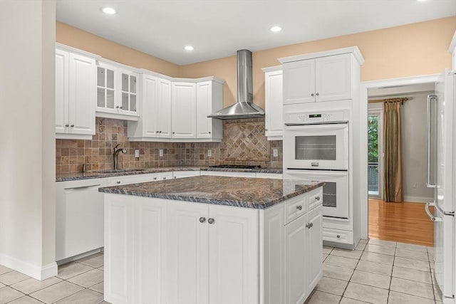 1205 Magnolia Dr Unit 1205, Wayland, MA 01778 - kitchen with wall chimney range hood, white appliances, light tile patterned floors, white cabinetry, and recessed lighting