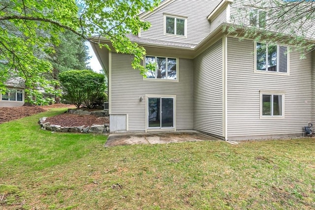 1205 Magnolia Dr Unit 1205, Wayland, MA 01778 - rear view of house with a lawn and a patio area
