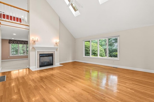 1205 Magnolia Dr Unit 1205, Wayland, MA 01778 - unfurnished living room featuring healthy amount of natural light, baseboards, wood finished floors, high vaulted ceiling, and a fireplace with flush hearth