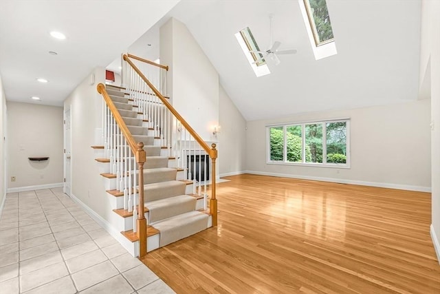 1205 Magnolia Dr Unit 1205, Wayland, MA 01778 - stairs with a skylight, baseboards, wood finished floors, a towering ceiling, and recessed lighting