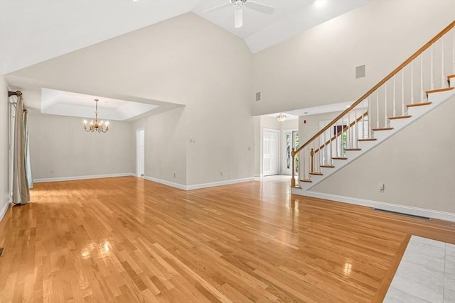 1205 Magnolia Dr Unit 1205, Wayland, MA 01778 - unfurnished living room featuring ceiling fan, a chandelier, light wood-type flooring, stairs, and high vaulted ceiling