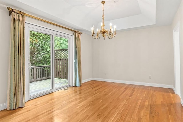 1205 Magnolia Dr Unit 1205, Wayland, MA 01778 - unfurnished room featuring a chandelier, baseboards, light wood finished floors, and a raised ceiling