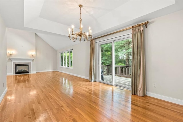 1205 Magnolia Dr Unit 1205, Wayland, MA 01778 - unfurnished living room with light wood-style floors, a chandelier, baseboards, and vaulted ceiling