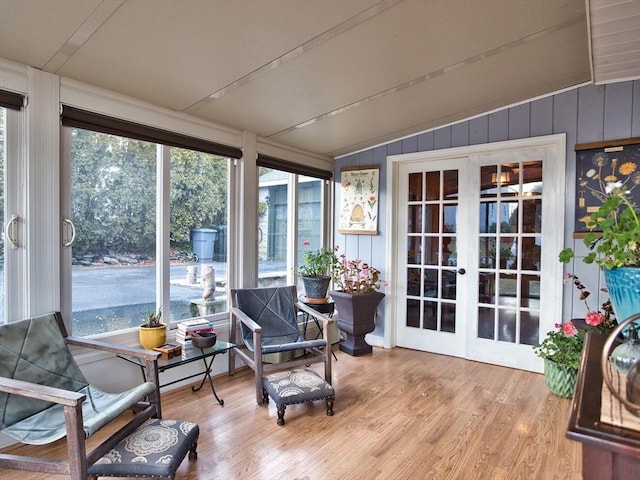 sunroom featuring lofted ceiling and french doors