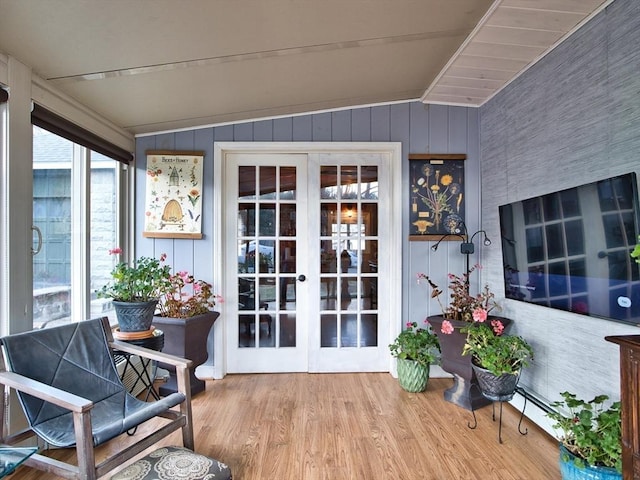 sunroom / solarium featuring vaulted ceiling and french doors