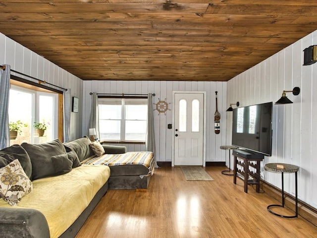 living room with light wood-type flooring, wood ceiling, wooden walls, and vaulted ceiling