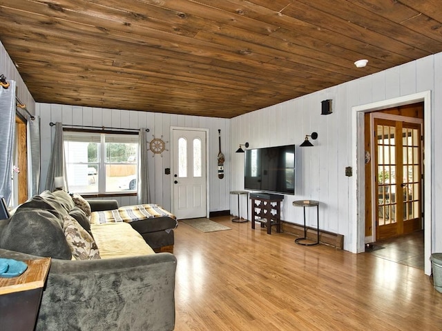 living room featuring hardwood / wood-style floors, wood walls, wood ceiling, and french doors