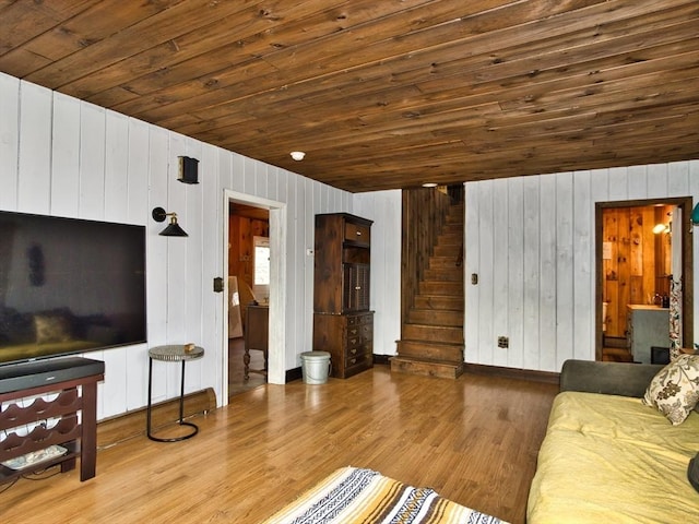 living room with wood walls, wood-type flooring, and wooden ceiling