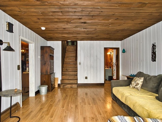 unfurnished living room featuring light hardwood / wood-style floors, wooden ceiling, and wood walls